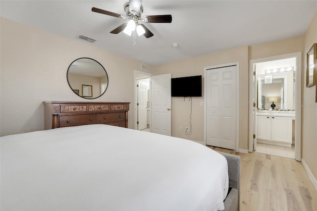 3938 Calabria Ave, Davenport, FL 33897 - bedroom with light wood-style floors, ensuite bathroom, baseboards, and a ceiling fan