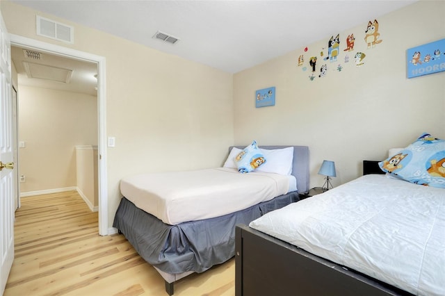 3938 Calabria Ave, Davenport, FL 33897 - bedroom featuring attic access, light wood-style floors, and baseboards