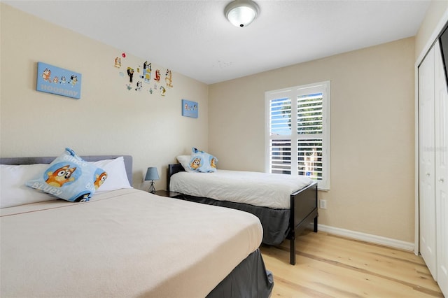 3938 Calabria Ave, Davenport, FL 33897 - bedroom with light wood-type flooring, a closet, and baseboards