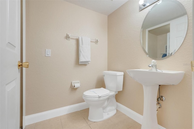 3938 Calabria Ave, Davenport, FL 33897 - bathroom featuring toilet, tile patterned flooring, and baseboards