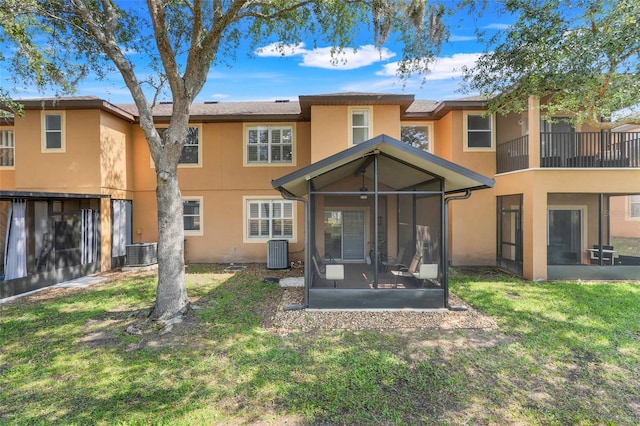 3938 Calabria Ave, Davenport, FL 33897 - rear view of house featuring a sunroom, stucco siding, cooling unit, and a yard