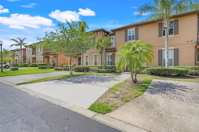3938 Calabria Ave, Davenport, FL 33897 - townhome / multi-family property featuring stucco siding and a residential view