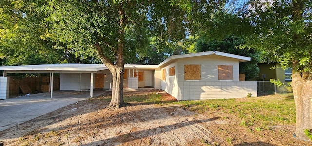 6113 Hialeah St, Orlando, FL 32808 - ranch-style house with a carport and driveway