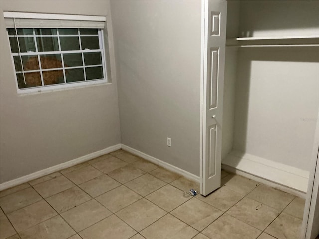6113 Hialeah St, Orlando, FL 32808 - unfurnished bedroom with tile patterned flooring and baseboards