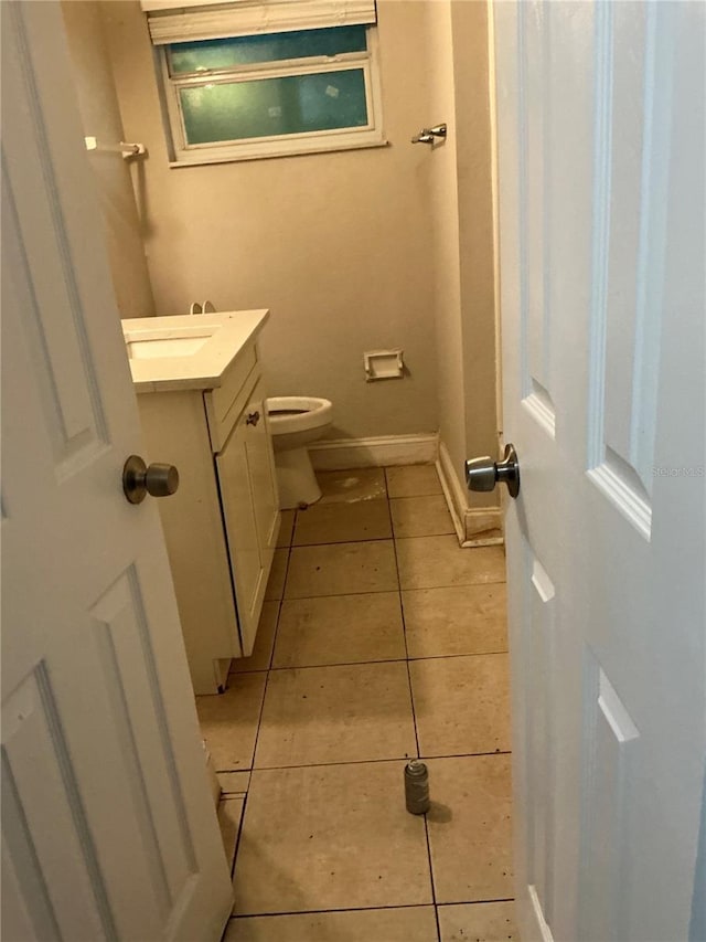 6113 Hialeah St, Orlando, FL 32808 - half bathroom with tile patterned floors, vanity, toilet, and baseboards