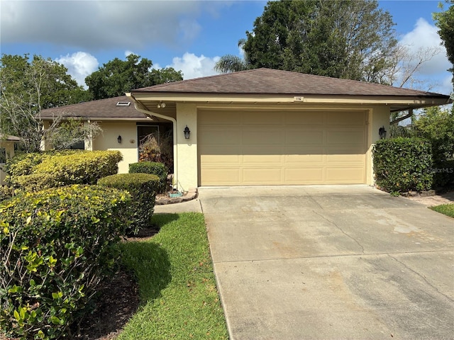 116 Oakmont Ln, New Smyrna Beach, FL 32168 - ranch-style house with stucco siding, driveway, a garage, and a shingled roof