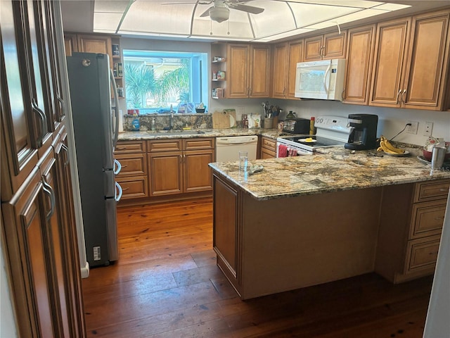 116 Oakmont Ln, New Smyrna Beach, FL 32168 - kitchen with white appliances, a sink, dark wood-type flooring, brown cabinetry, and a ceiling fan