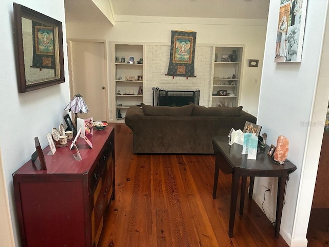 116 Oakmont Ln, New Smyrna Beach, FL 32168 - living area featuring wood finished floors, built in shelves, and a brick fireplace