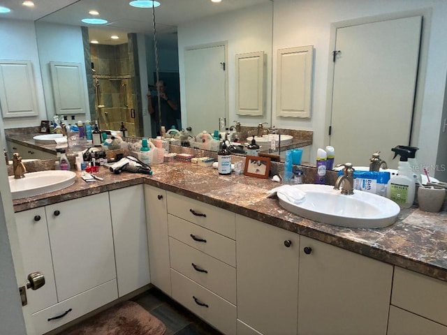 116 Oakmont Ln, New Smyrna Beach, FL 32168 - bathroom featuring a shower stall, double vanity, and recessed lighting