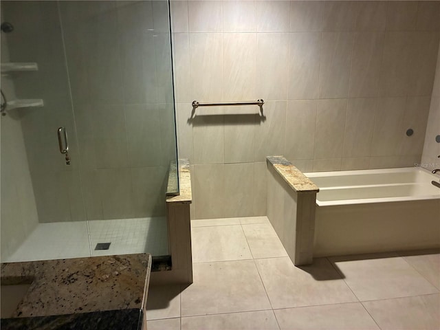 116 Oakmont Ln, New Smyrna Beach, FL 32168 - full bath with tile patterned flooring, a stall shower, tile walls, and a garden tub