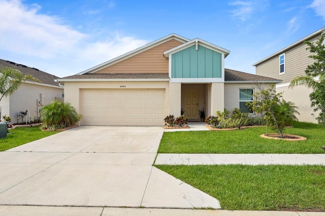 4444 Quartz Ct, Lakeland, FL 33811 - view of front facade featuring concrete driveway, a front lawn, stucco siding, and an attached garage
