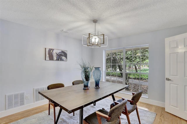140 Sweet Bay Cir, Lake Mary, FL 32746 - dining room with a chandelier, baseboards, light wood-type flooring, and a textured ceiling