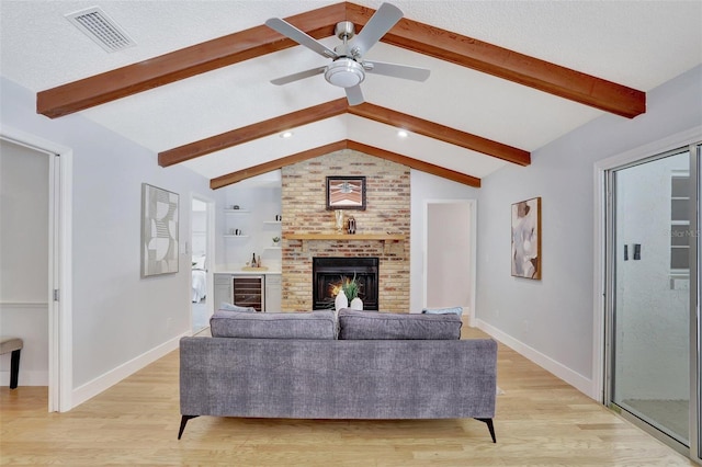 140 Sweet Bay Cir, Lake Mary, FL 32746 - living room featuring ceiling fan, a fireplace, baseboards, and light wood finished floors