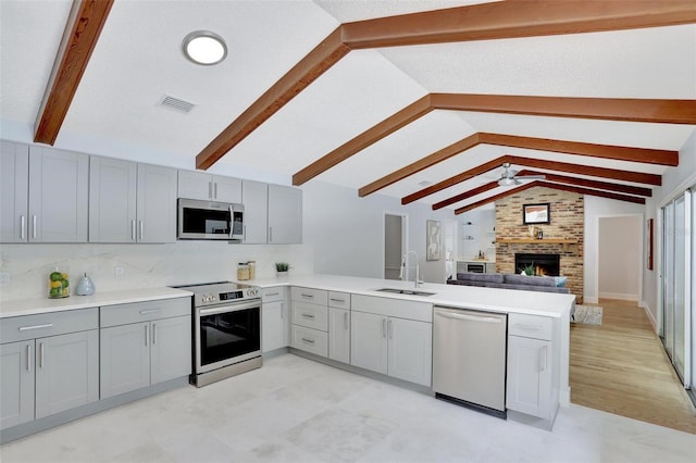 140 Sweet Bay Cir, Lake Mary, FL 32746 - kitchen with stainless steel appliances, gray cabinetry, a peninsula, and a sink