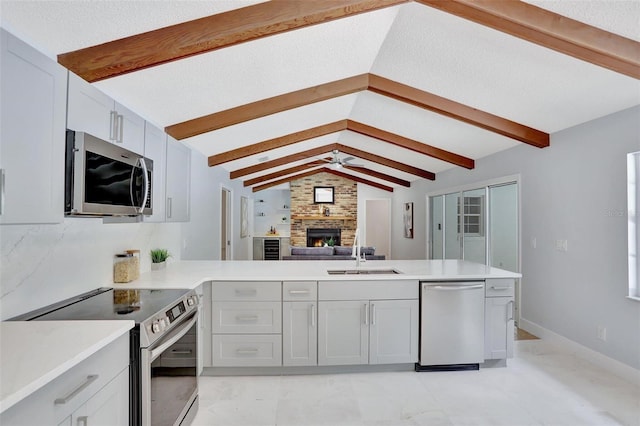 140 Sweet Bay Cir, Lake Mary, FL 32746 - kitchen with stainless steel appliances, a sink, a peninsula, and light countertops