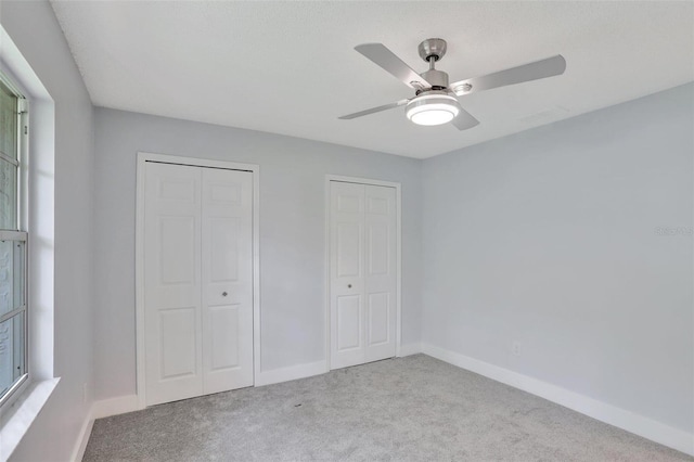 140 Sweet Bay Cir, Lake Mary, FL 32746 - unfurnished bedroom featuring carpet flooring, multiple closets, baseboards, and a ceiling fan