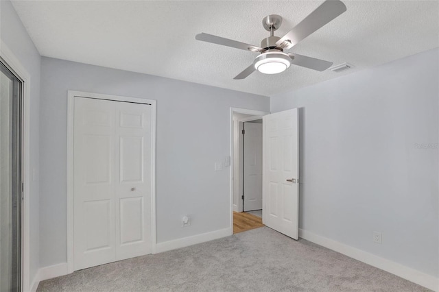 140 Sweet Bay Cir, Lake Mary, FL 32746 - unfurnished bedroom with carpet floors, a closet, a textured ceiling, a ceiling fan, and baseboards
