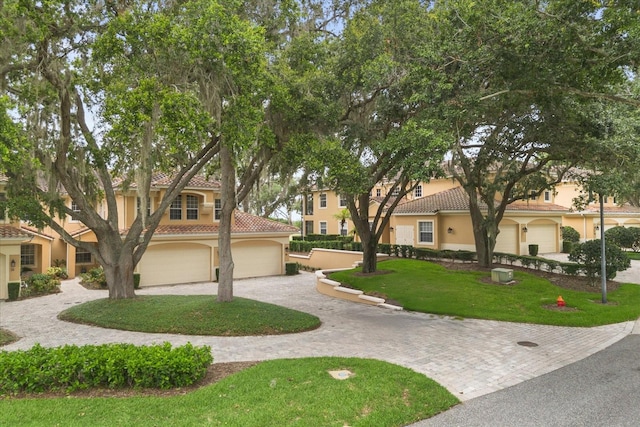 14 Camino Real Blvd Unit 14, Howey In The Hills, FL 34737 - view of front of property featuring a tile roof, curved driveway, and stucco siding
