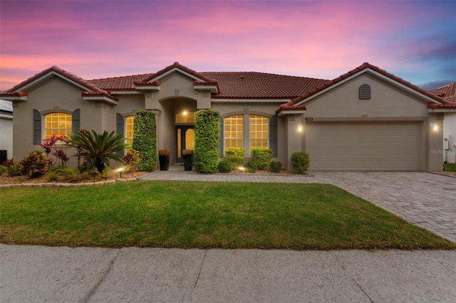 2359 Baronsmede Ct, Winter Garden, FL 34787 - mediterranean / spanish-style house featuring stucco siding, an attached garage, a tile roof, and decorative driveway
