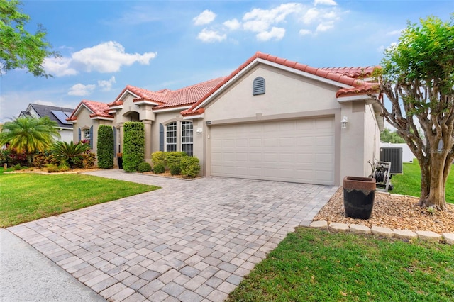 2359 Baronsmede Ct, Winter Garden, FL 34787 - mediterranean / spanish house featuring stucco siding, a tiled roof, a front lawn, and decorative driveway