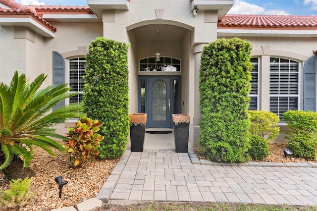 2359 Baronsmede Ct, Winter Garden, FL 34787 - doorway to property with stucco siding and a tiled roof