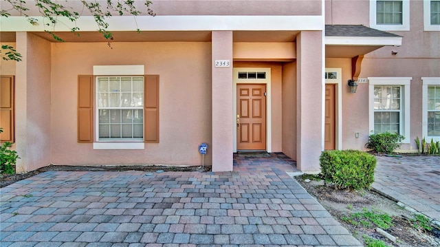 2343 Caravelle Cir, Kissimmee, FL 34746 - doorway to property with stucco siding