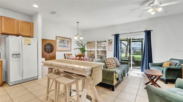 2343 Caravelle Cir, Kissimmee, FL 34746 - living room with light tile patterned floors, ceiling fan, recessed lighting, and a chandelier