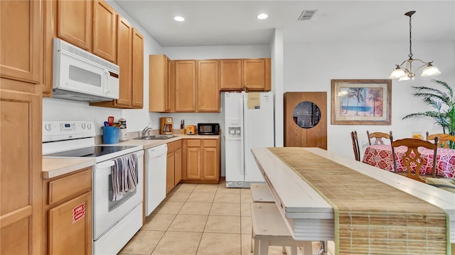 2343 Caravelle Cir, Kissimmee, FL 34746 - kitchen featuring white appliances, a chandelier, light tile patterned floors, light countertops, and a sink