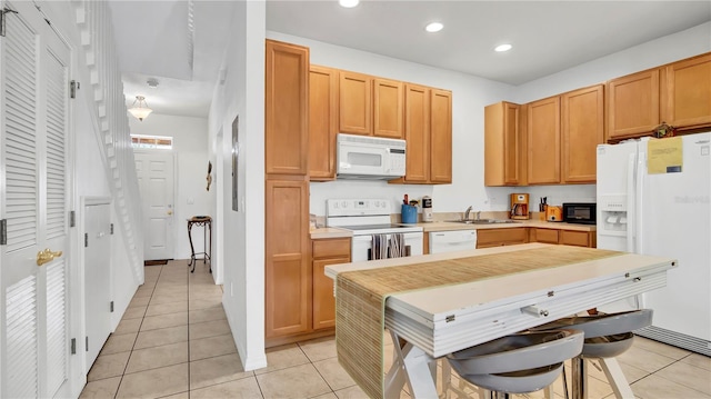 2343 Caravelle Cir, Kissimmee, FL 34746 - kitchen featuring white appliances, a sink, light tile patterned floors, recessed lighting, and light countertops