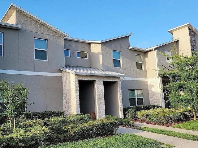 456 Ocean Course Ave, Davenport, FL 33896 - view of front of property with stucco siding, a standing seam roof, and metal roof