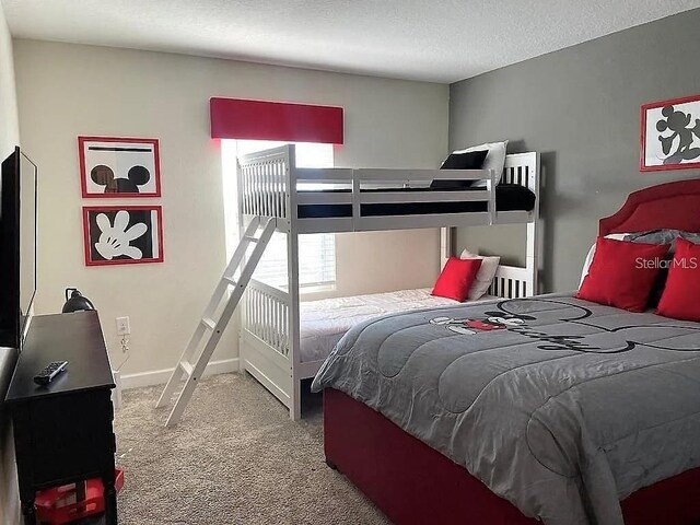 456 Ocean Course Ave, Davenport, FL 33896 - carpeted bedroom featuring baseboards and a textured ceiling