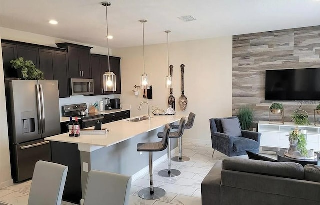 456 Ocean Course Ave, Davenport, FL 33896 - kitchen featuring open floor plan, appliances with stainless steel finishes, a sink, and recessed lighting