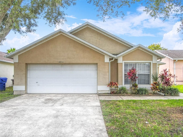 2314 Cormorant St, Kissimmee, FL 34743 - ranch-style home with stucco siding, an attached garage, and driveway