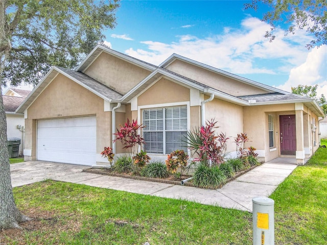 2314 Cormorant St, Kissimmee, FL 34743 - single story home featuring stucco siding, an attached garage, a front yard, and concrete driveway