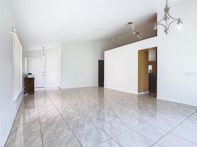 2314 Cormorant St, Kissimmee, FL 34743 - spare room with vaulted ceiling and rail lighting