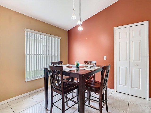 2314 Cormorant St, Kissimmee, FL 34743 - dining room featuring lofted ceiling, light tile patterned floors, and baseboards
