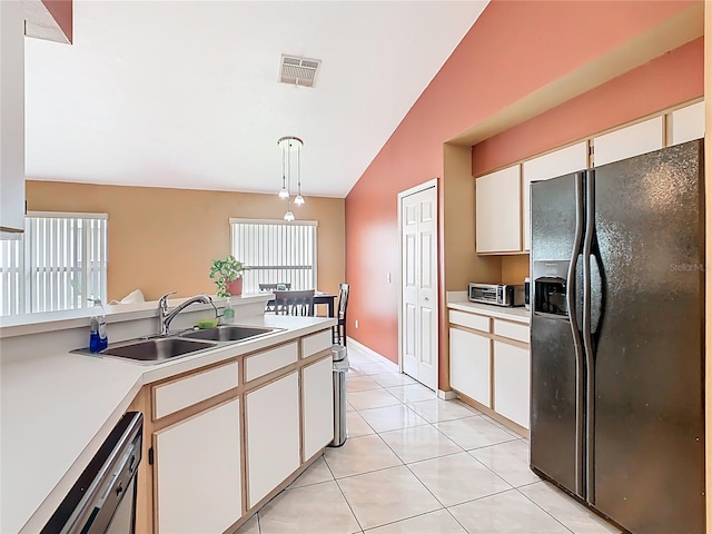 2314 Cormorant St, Kissimmee, FL 34743 - kitchen featuring black refrigerator with ice dispenser, a sink, dishwashing machine, light countertops, and lofted ceiling