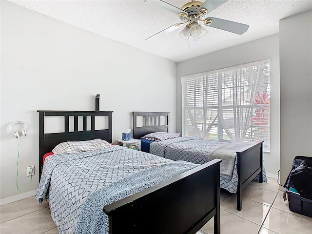 2314 Cormorant St, Kissimmee, FL 34743 - bedroom featuring light tile patterned flooring, a ceiling fan, baseboards, and a textured ceiling