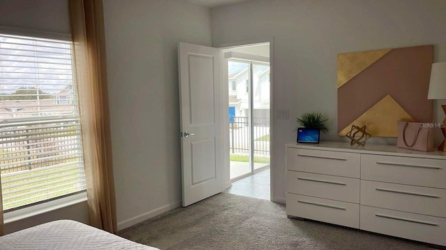 2002 Punch Bowl Ave, Davenport, FL 33837 - bedroom with access to exterior, multiple windows, and light carpet