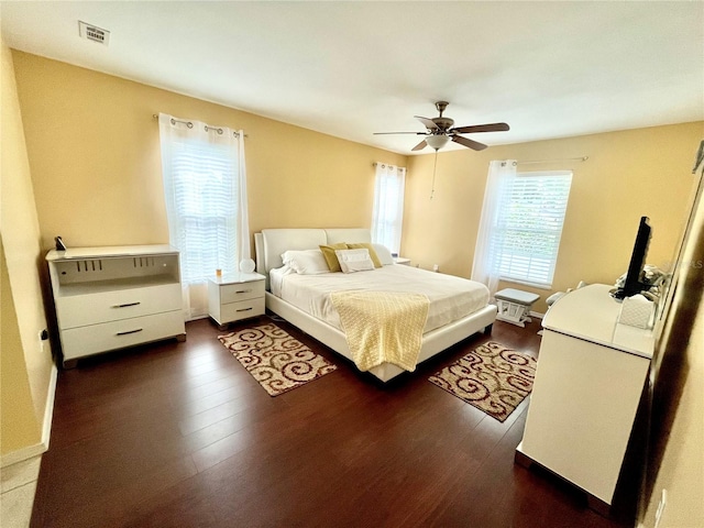 7011 Archwood Dr, Orlando, FL 32819 - bedroom with dark wood-type flooring and ceiling fan