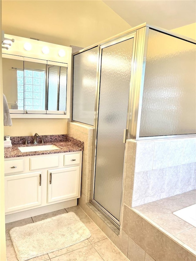 7011 Archwood Dr, Orlando, FL 32819 - bathroom with vanity, a stall shower, a garden tub, and tile patterned flooring
