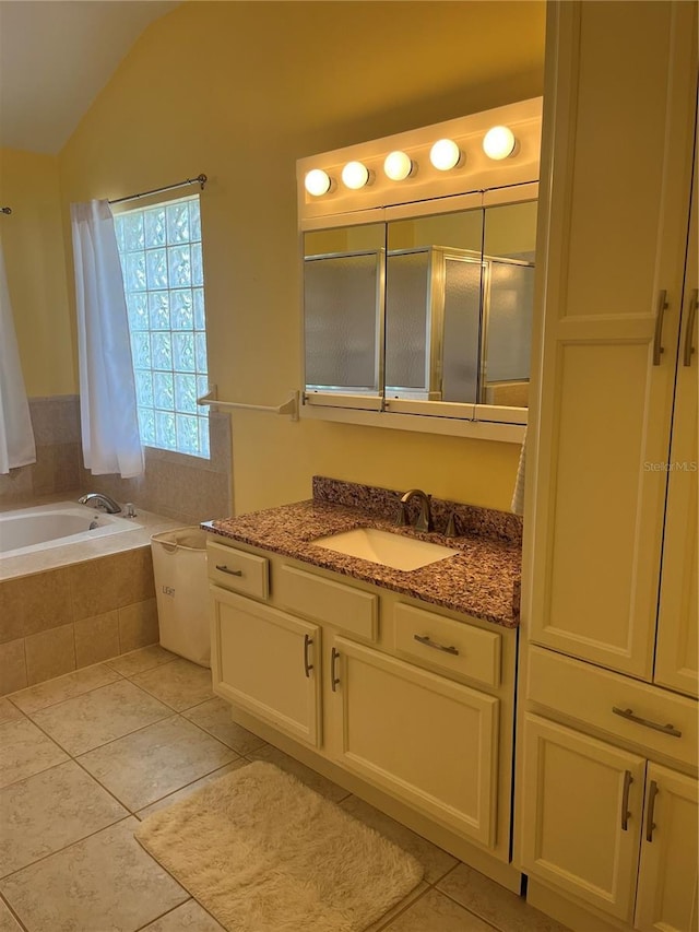 7011 Archwood Dr, Orlando, FL 32819 - bathroom featuring vanity, a garden tub, tile patterned flooring, and vaulted ceiling