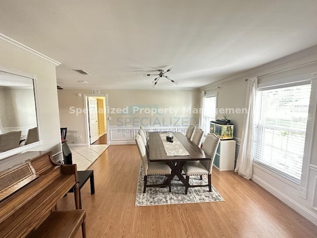 7011 Archwood Dr, Orlando, FL 32819 - dining room with ornamental molding, light wood finished floors, and baseboards