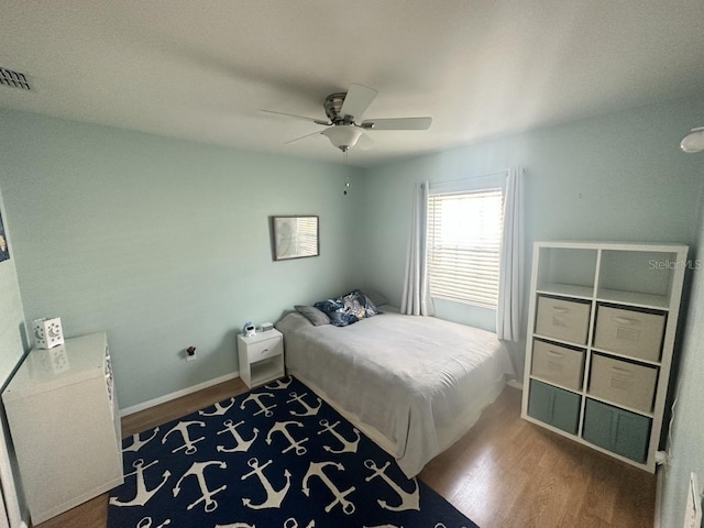 7011 Archwood Dr, Orlando, FL 32819 - bedroom featuring dark wood-style flooring, ceiling fan, and baseboards