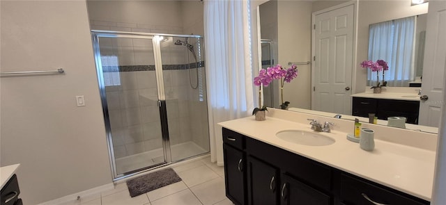 1544 Nassau Point Trl, Kissimmee, FL 34747 - full bathroom with vanity, a stall shower, tile patterned flooring, and baseboards