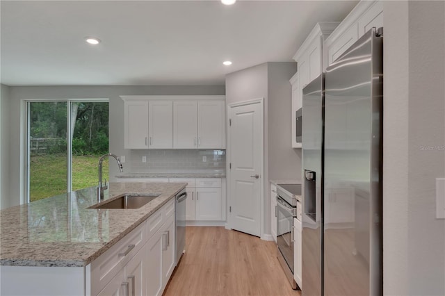 327 Larch Rd, Ocala, FL 34480 - kitchen featuring a sink, stainless steel appliances, white cabinetry, light wood finished floors, and recessed lighting