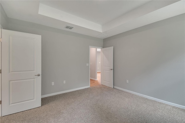 327 Larch Rd, Ocala, FL 34480 - unfurnished bedroom with light colored carpet, baseboards, and a tray ceiling