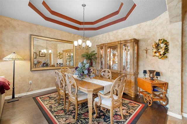 3551 Statham Dr, Apopka, FL 32712 - dining room with a chandelier, wood finished floors, baseboards, and a tray ceiling