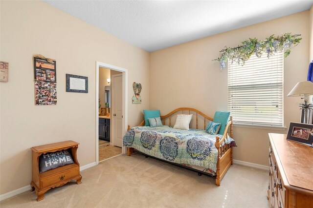 3551 Statham Dr, Apopka, FL 32712 - bedroom featuring light carpet, baseboards, and connected bathroom