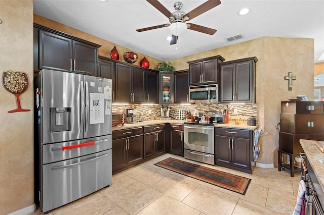 3551 Statham Dr, Apopka, FL 32712 - kitchen featuring appliances with stainless steel finishes, a ceiling fan, backsplash, and dark brown cabinets